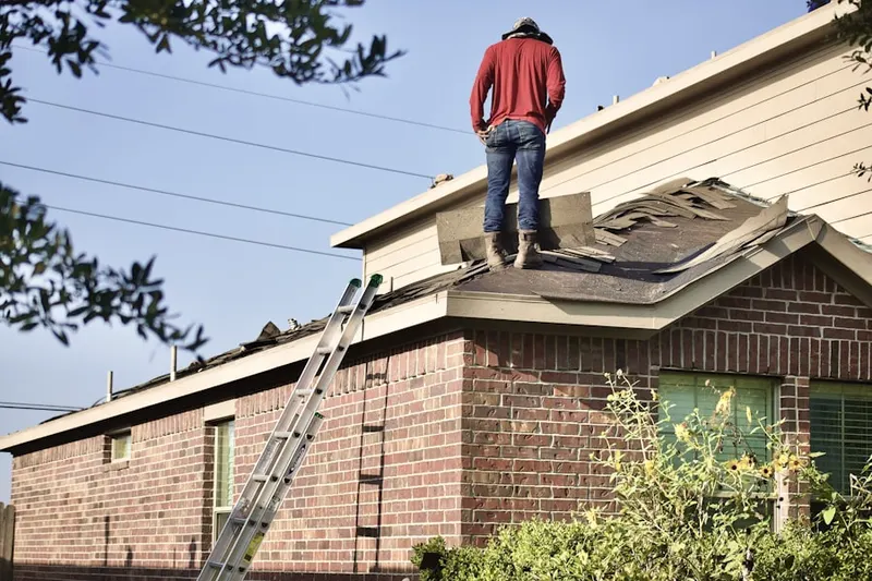 Professional roofer working on a residential roof in Logan Circle